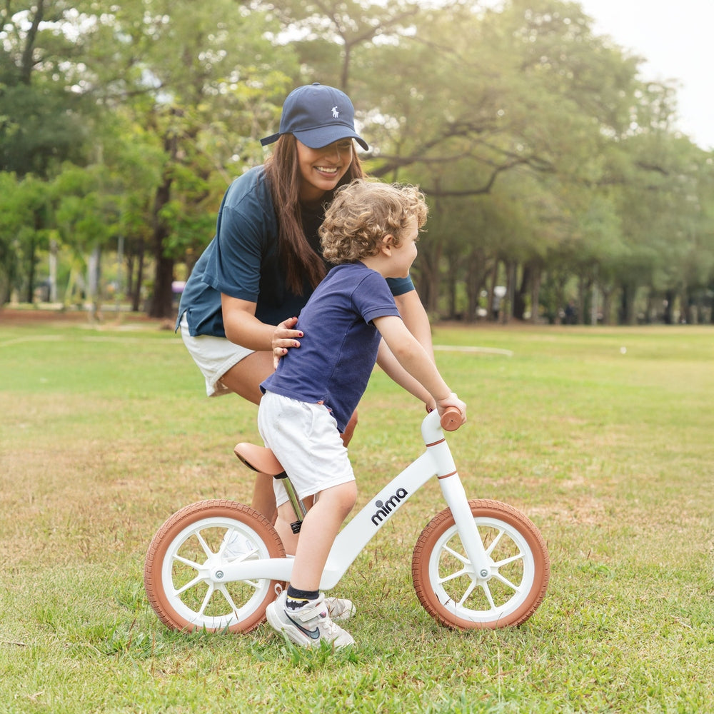 Mima Zoom Lite Balance Bike in White park lifestyle scene