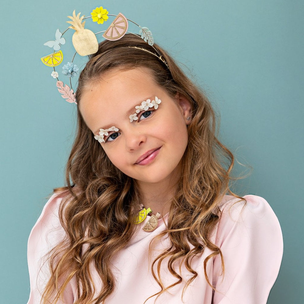 Mimi & Lula Citrus Slice Clips worn by a girl with pastel floral crown and citrus shapes