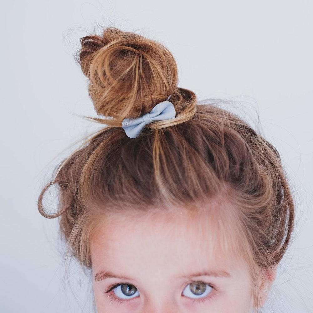 Mimi & Lula Gracie Ponies Pink hair tie in a top knot with a light blue scrunchie