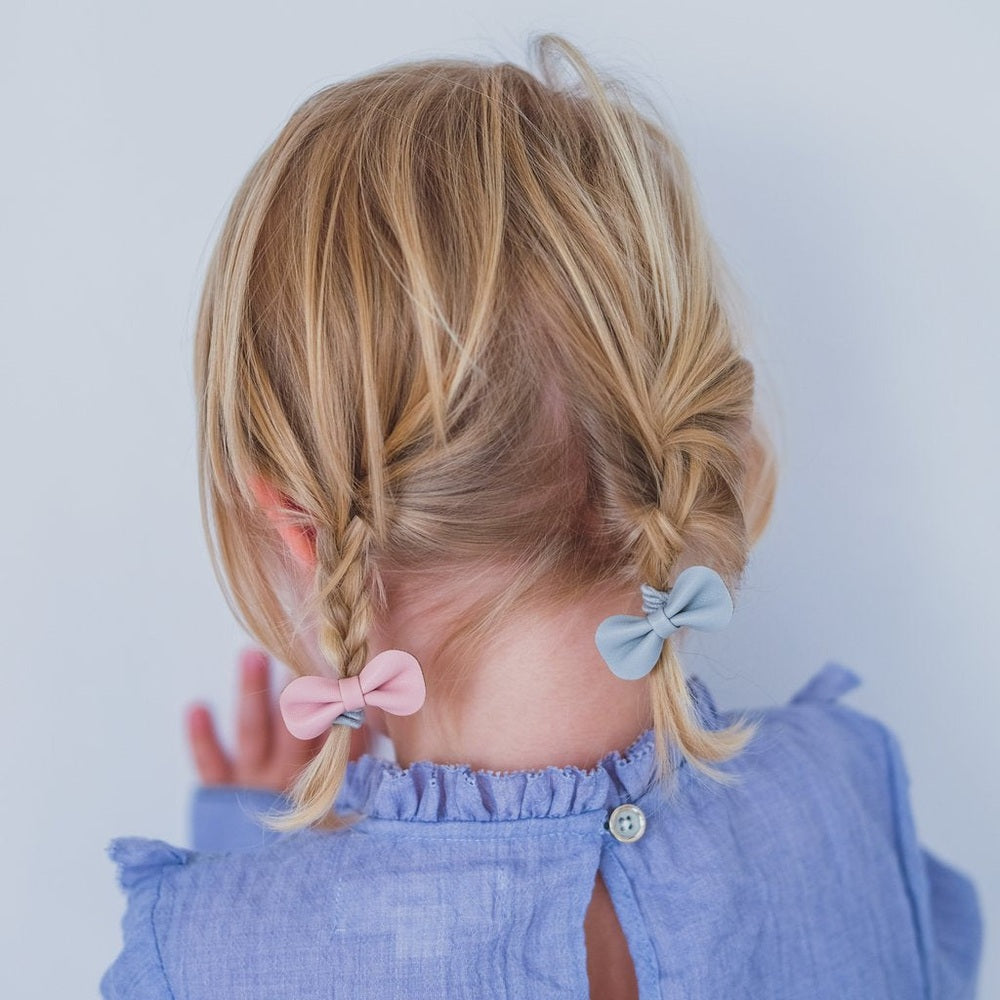 Mimi & Lula Gracie Ponies Pink hair bows on twin braids with pink and blue ribbons, blue top