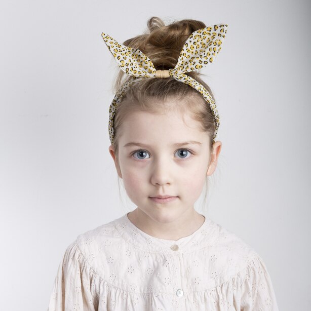 Mimi & Lula Jungle Coco Bow Alice Band leopard print headband on young girl.