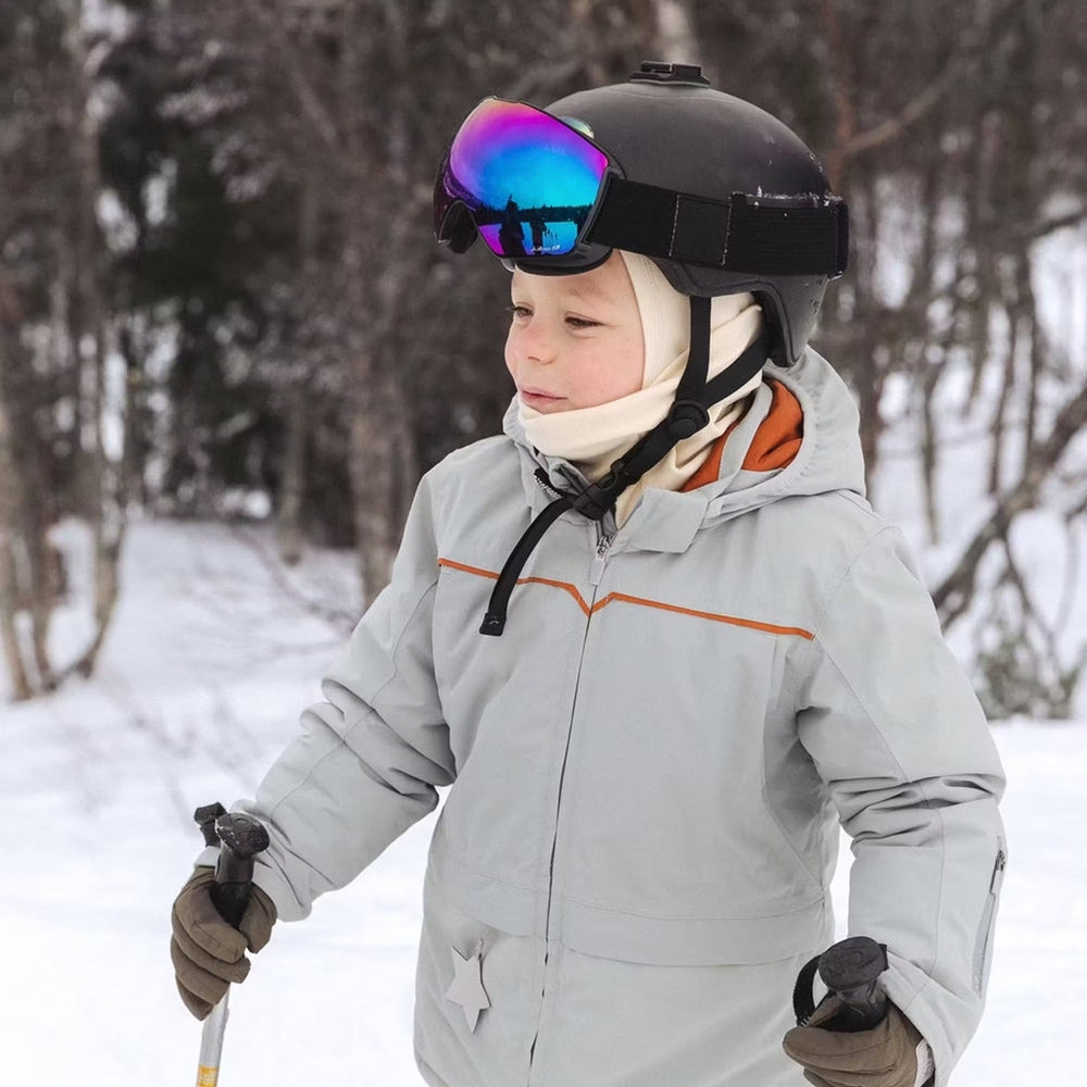 Mini A Ture Matadane Ski Tech Jacket Grs Quarry worn by a child in snowy woods, skiing with poles