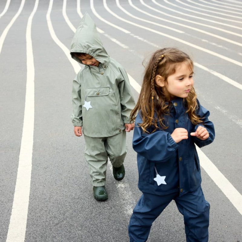 MINI A TURE Matreinar rain set; green and navy outerwear with star patches, worn by two children