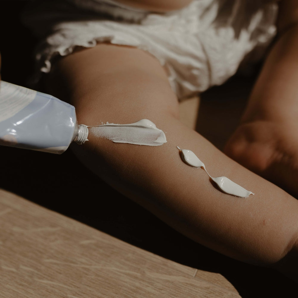 Minois Paris Diaper Cream 50 ml, creamy white lotion being applied to skin on the arm