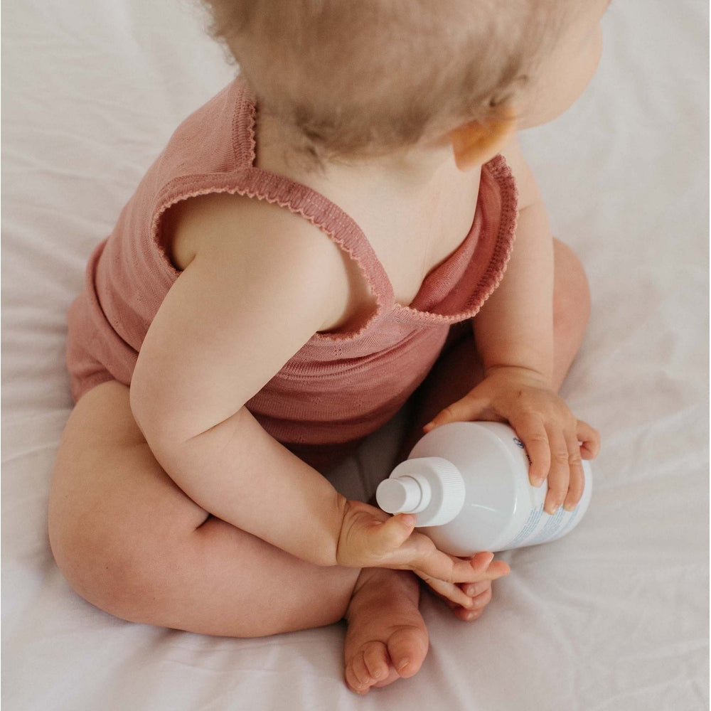 MINOIS PARIS Light Water 250 ml bottle held by a baby in a pink romper