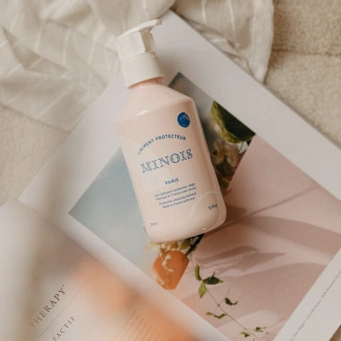 Minois Paris Liniment Protector 300 ml pump bottle in pink on a magazine page