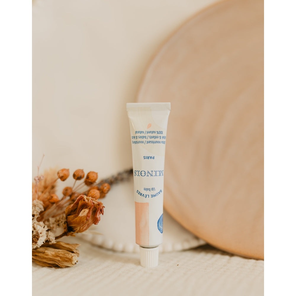 Minois Paris lip balm 12 ml tube with pastel peach and blue artwork, MINOIS PARIS branding.