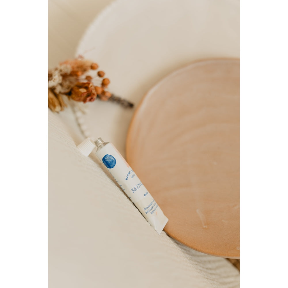 Minois Paris lip balm 12 ml in white tube with blue logo, skincare cosmetic