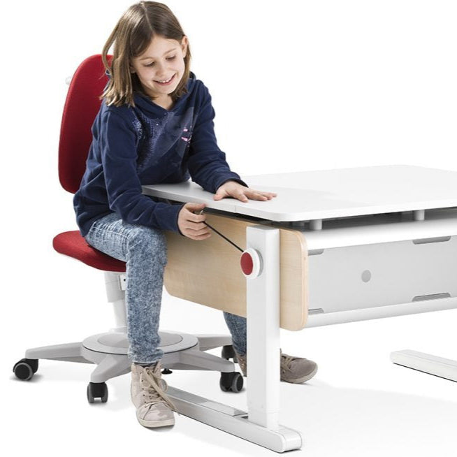 Moll Champion Height Adjustable Desk Front Up for kids, white tabletop and wooden legs; child adjusts height with red control knob.