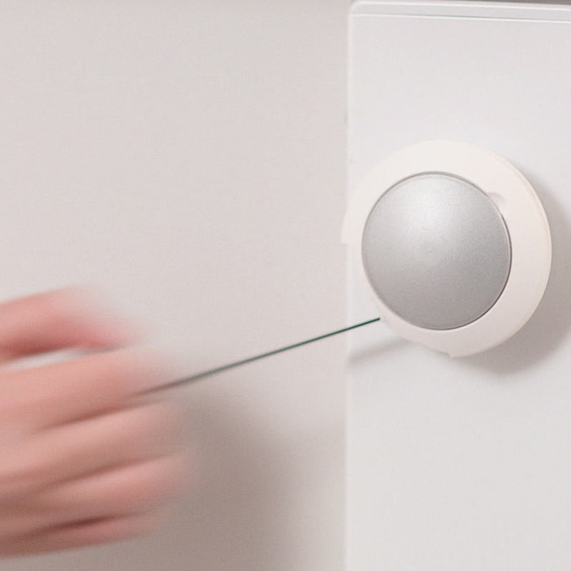 Moll Champion Height Adjustable Desk Front Up, white frame with a silver round adjustment knob; hand adjusts height by guiding a rod.