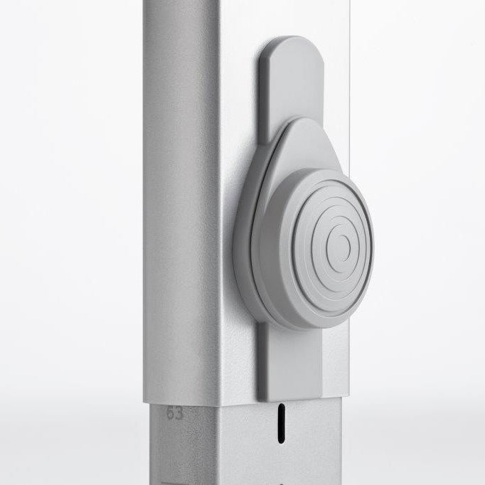 Moll Sprinter height-adjustable desk leg with gray circular knob being turned to adjust height.