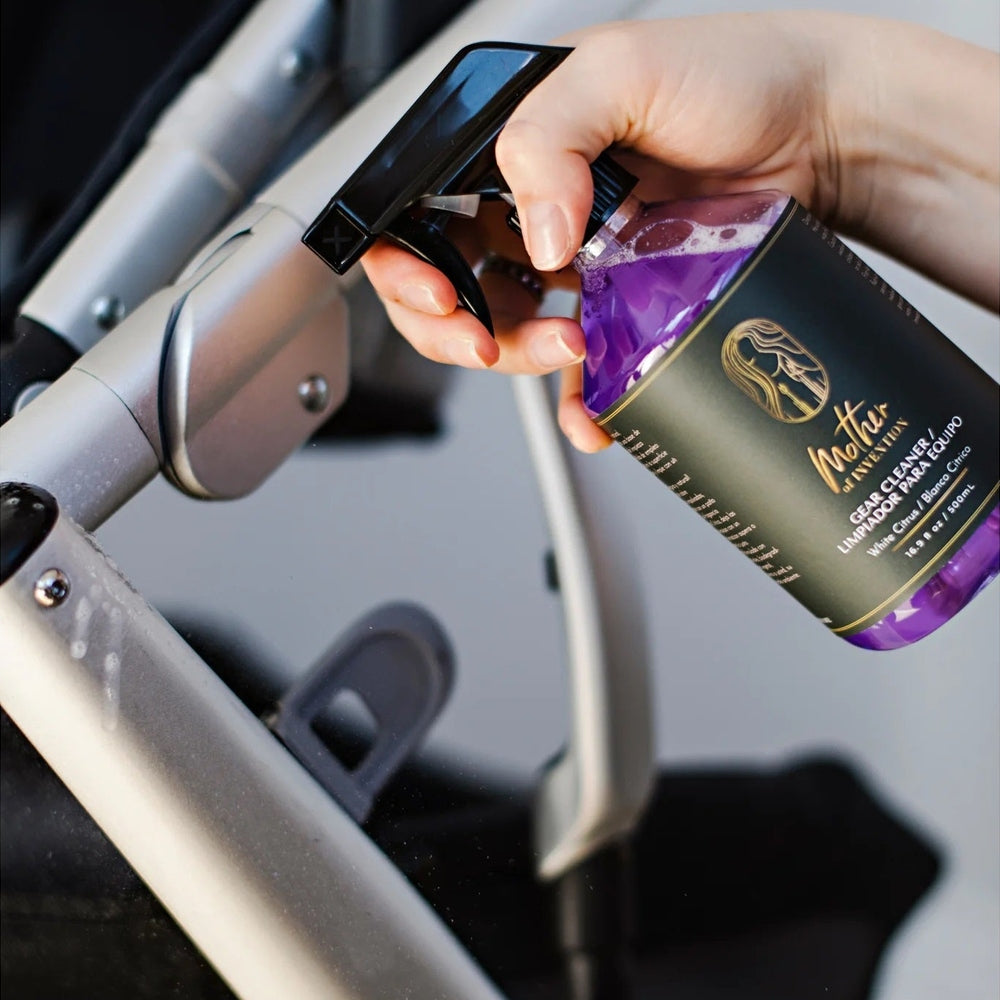 Mother Of Invention 500 ml multi-purpose cleaner being sprayed on a stroller frame