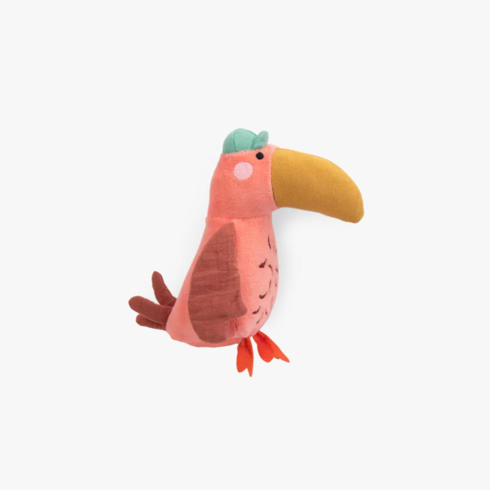 Moulin Roty parrot plush toy in pink with orange beak, green crest, and brown wing details.