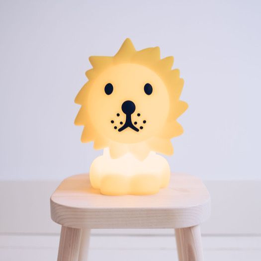 MR MARIA First Light Lion night light with warm yellow glow on a wooden stool