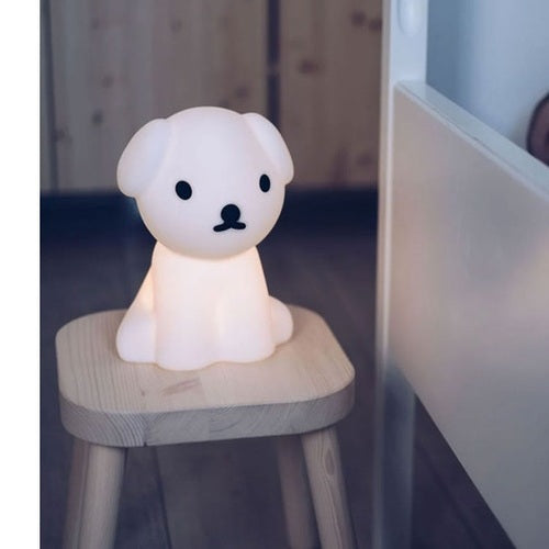 Mr Maria First Light Snuffy night light in white dog figure glowing softly on a wooden stool