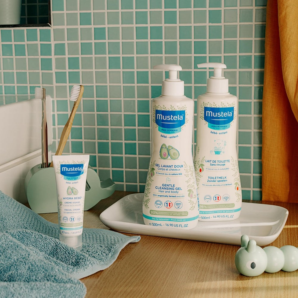 Mustela Hydra Baby Face Cream with Organic Avocado 40 ml; kit with one tube and two bottles on a tiled bathroom counter