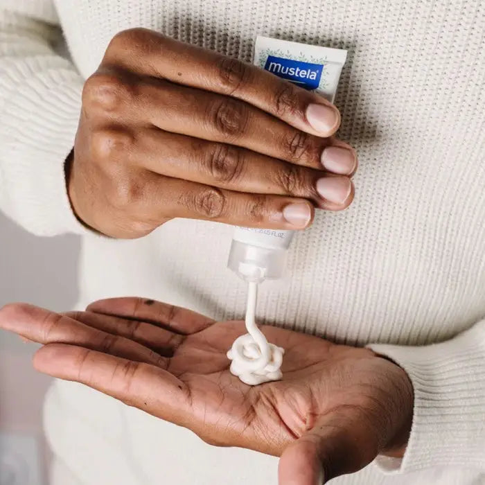 Mustela Nourishing Cream with Cold Cream (40 ml) dispensed onto hand; white, rich cream texture