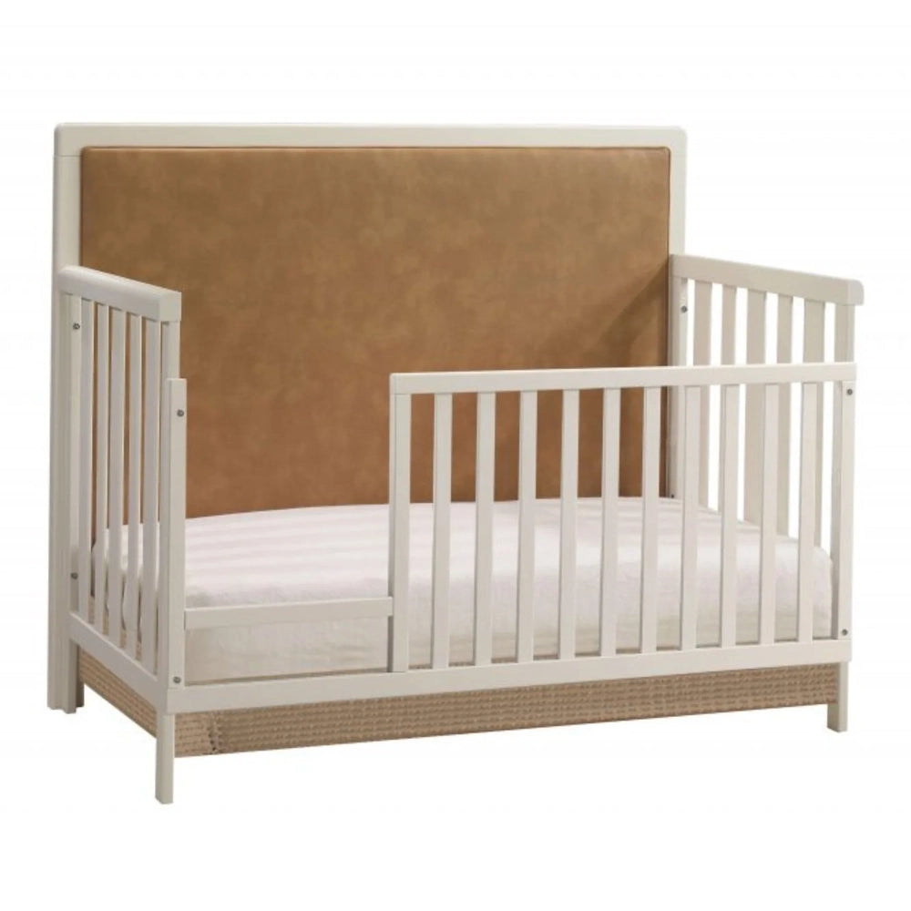 Natart Kyoto 5-in-1 convertible crib with white frame and tan leather upholstered panel