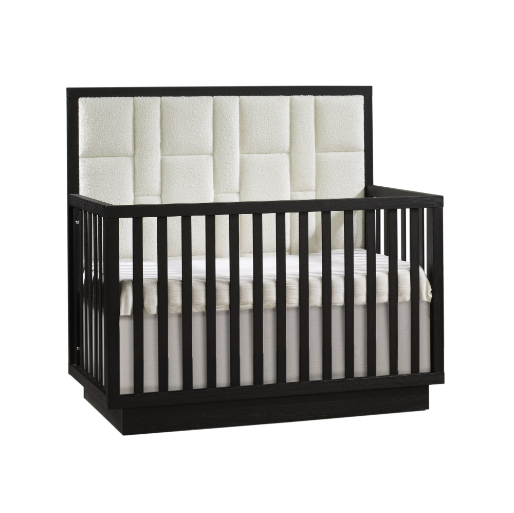 Natart Como 4-in-1 convertible crib, black finish with cream geometric upholstered panel.