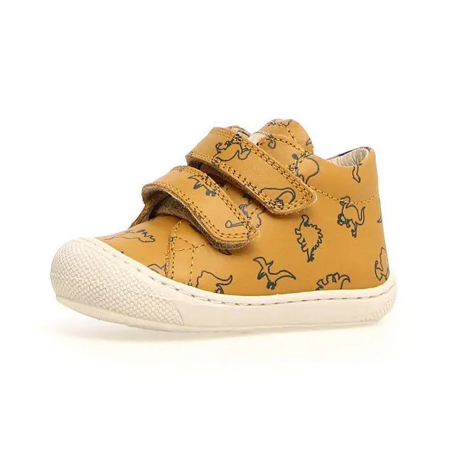 Naturino Cocoon Vl Dino toddler sneakers in mustard yellow with dinosaur print and Velcro straps fastened