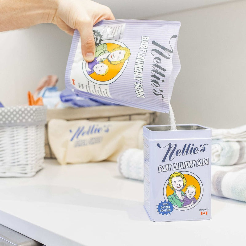 Nellie's Baby Laundry Soda canister with purple packaging being poured; baby illustration on label.