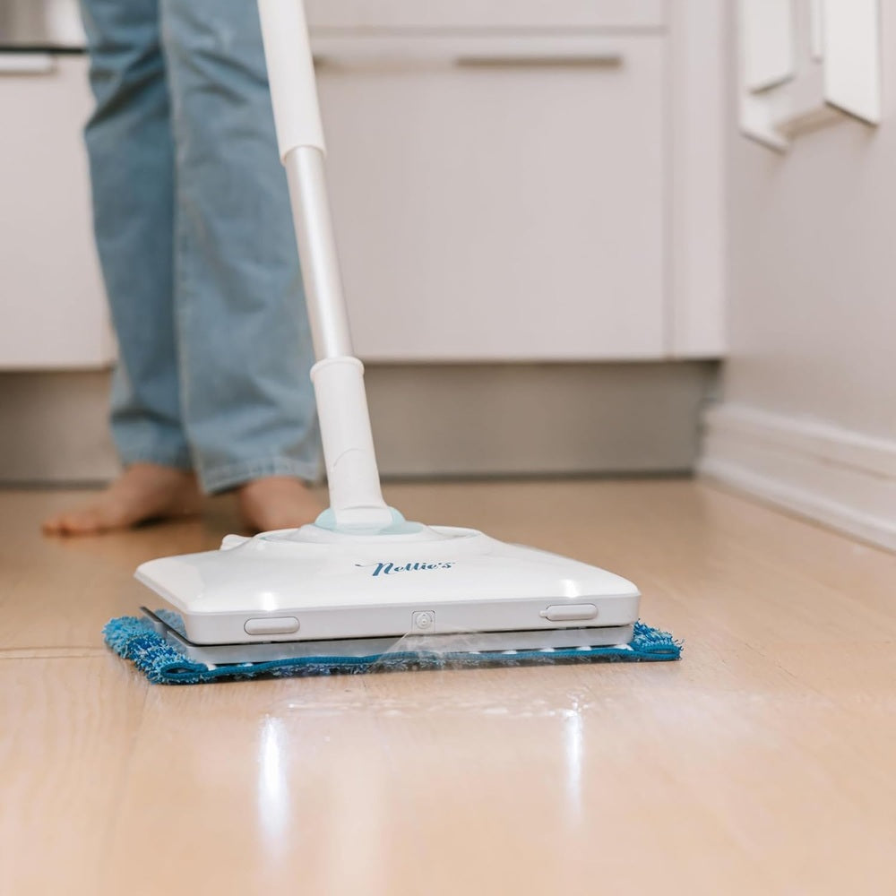 Nellie's Wow Mop gliding over hardwood floor with a blue microfiber pad and white handle.