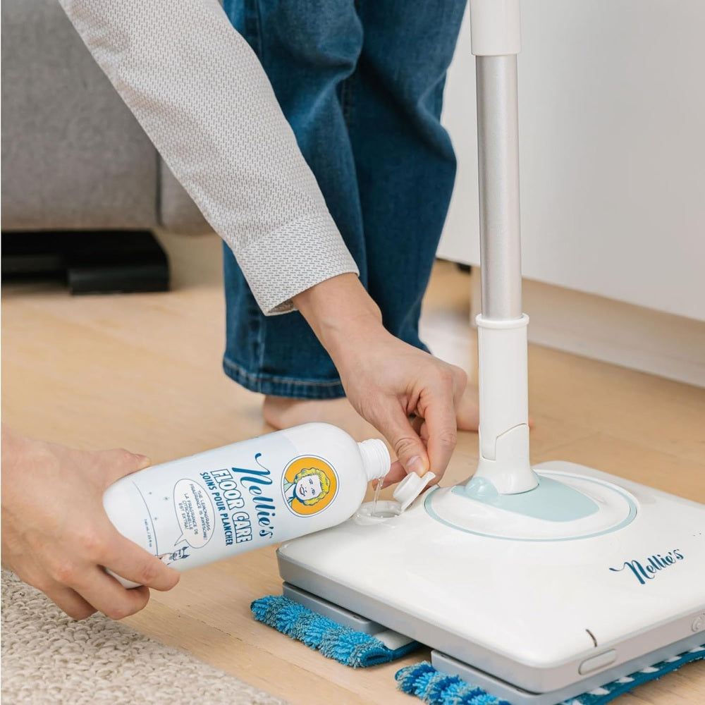 Nellie's Wow Mop with a blue microfiber pad, cleaner poured onto the mop head for ready cleaning.