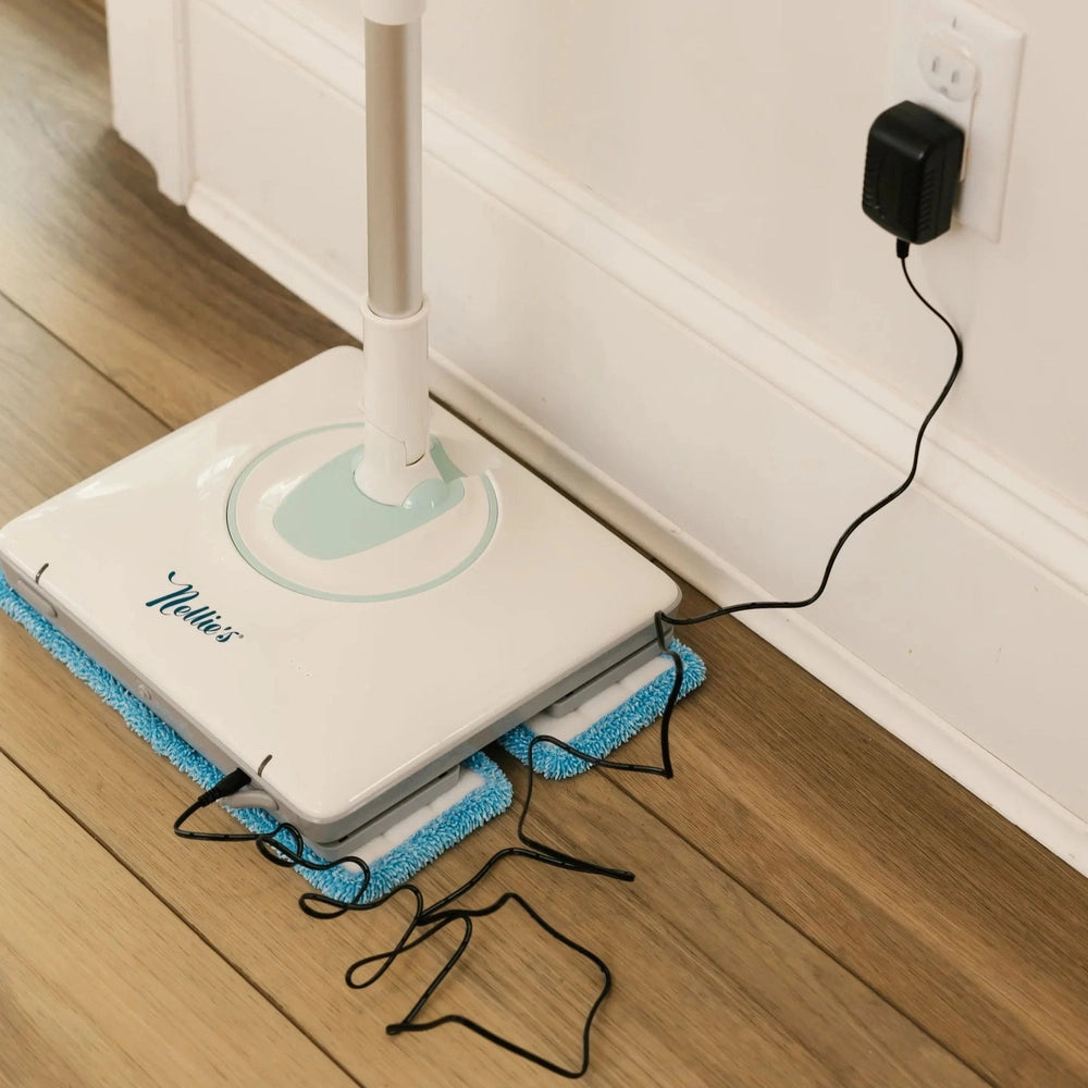 Nellie's Wow Mop charging base with blue microfiber pads, white and teal accents