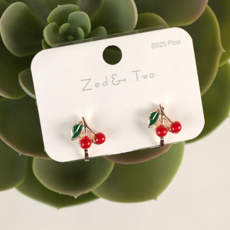 Nemibaby Earrings: silver-tone cherry stud pair with green leaves and red berries, displayed on a white card
