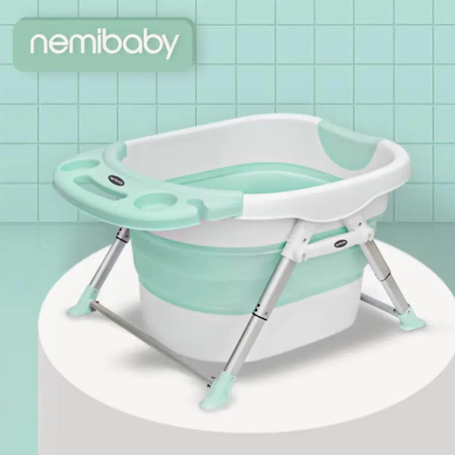 Nemibaby Foldable Baby/Toddler 4 In 1 Bathtub in mint green and white, with extended metal legs for stability.