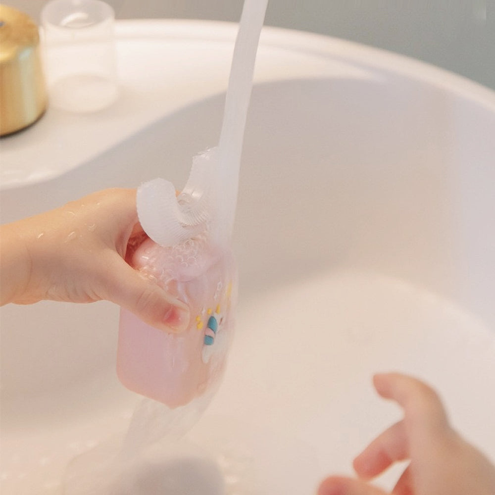 Nemibaby Kids U-Shape Toothbrush blue held under running water for rinsing