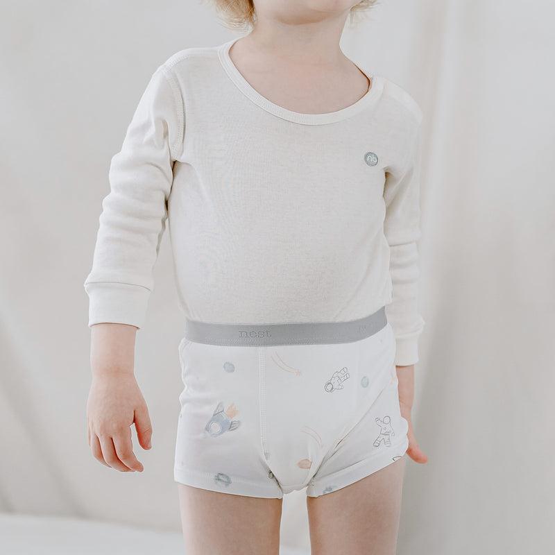 Nest Designs Bamboo Boys Boxer Briefs Underwear To Infinity two-pack; gray waistband, space-patterned print, worn by toddler.