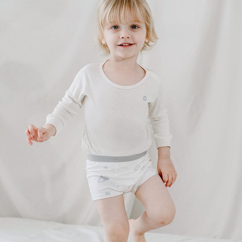 Nest Design Bamboo Boys Boxer Briefs Underwear 2-Pack To Infinity; toddler stands smiling, showing soft breathable fabric.