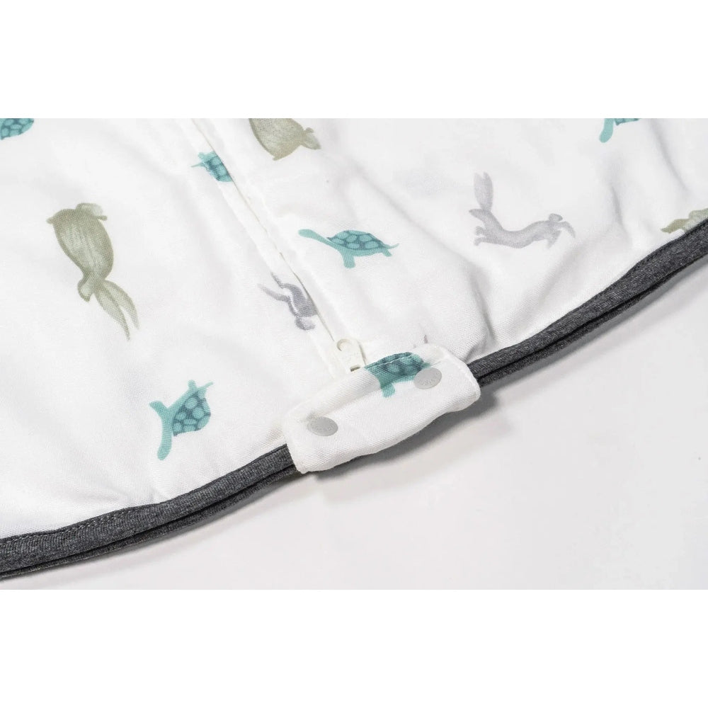 Nest Designs 0.23 Tog Bamboo Sleep Bag The Tortoise & The Hare print, white with gray trim, shoulder snaps fastened.