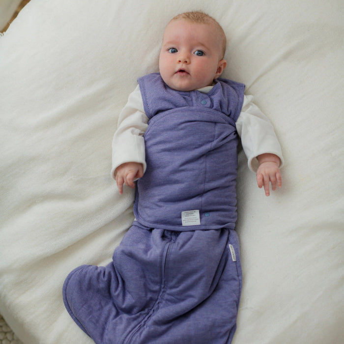 Nest Designs Avocado Bamboo Swaddle Sleep Bag Twilight Purple worn by baby in white long-sleeve bodysuit