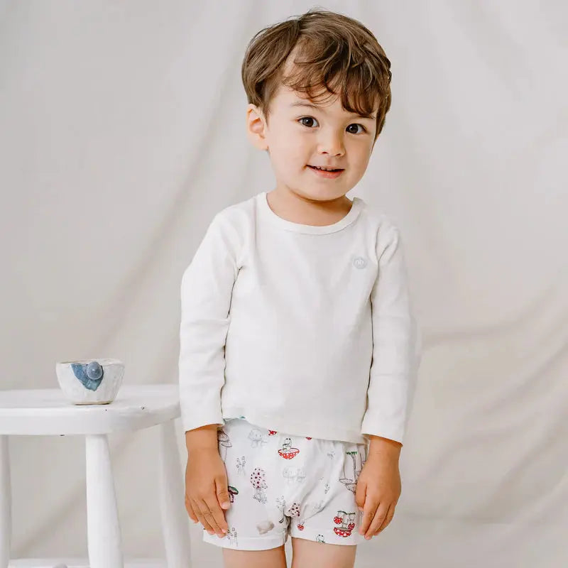 Nest Designs Bamboo Boys Boxer Briefs Underwear (2 Pack) Meadow Mystery worn by a toddler in a white shirt, showing meadow prints