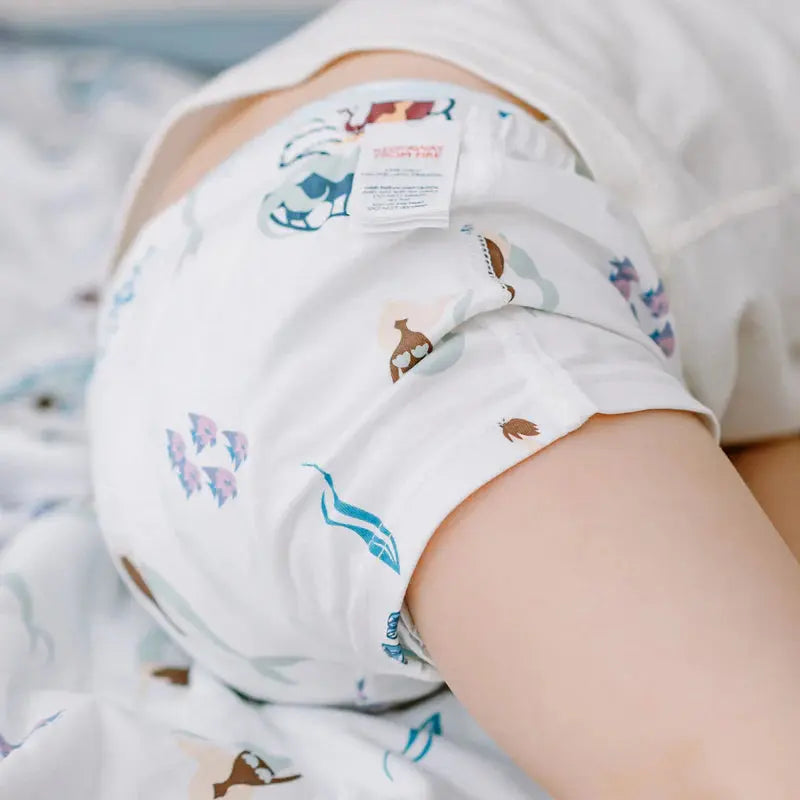 Nest Designs Bamboo Boys Boxer Briefs Under The Sea 2-pack, white underwear with blue sea prints, worn by a toddler.