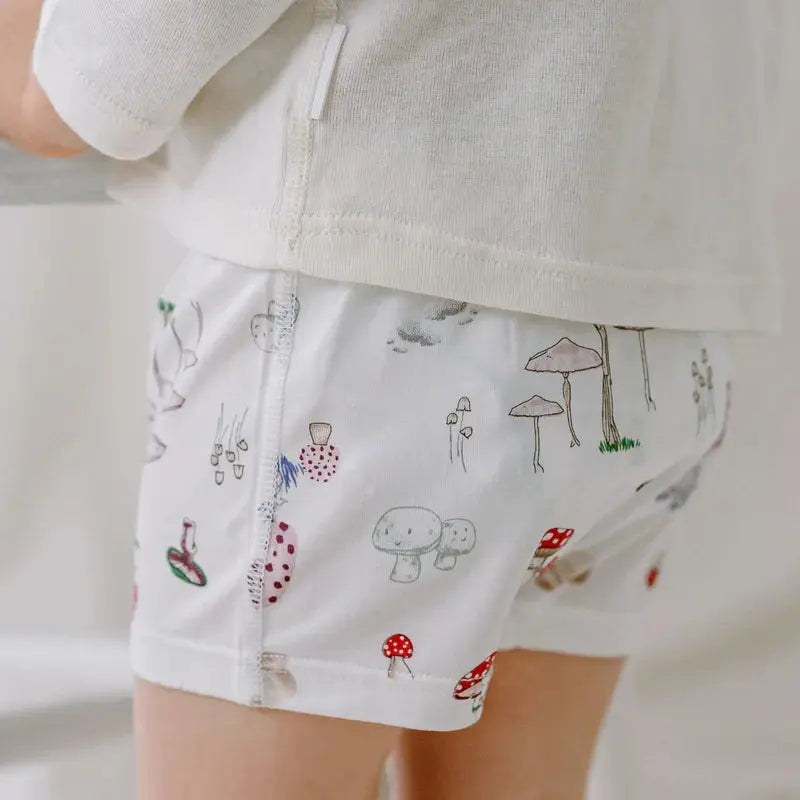 Nest Designs Bamboo Boys Boxer Briefs Underwear Meadow Mystery 2-pack worn by child; white fabric with mushroom print.