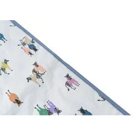 Nest Designs Bamboo Cotton Waterproof Change Pad Serengeti spread on a changing surface with blue trim and playful animal prints