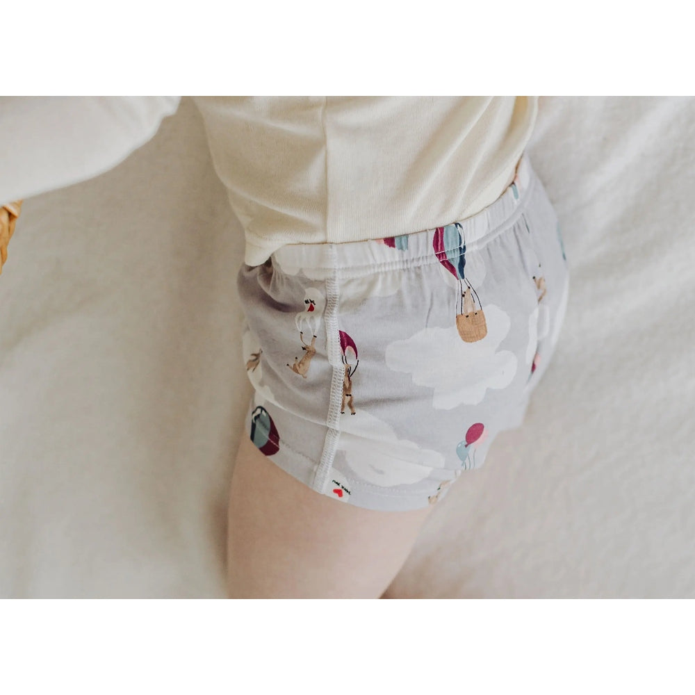 Nest Designs bamboo girls' boy short underwear Sahara Sky two-pack; gray with clouds and balloons, worn by a child