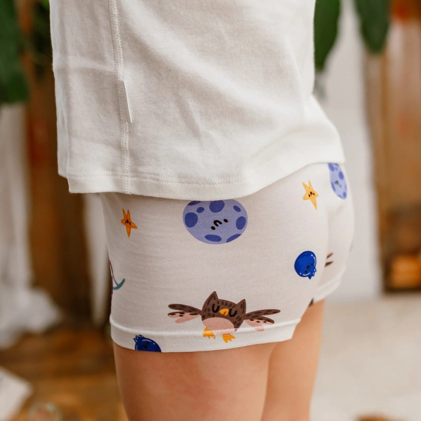 Nest Designs bamboo jersey boys boxer briefs 2-pack, white with space-themed prints like moons, stars, and owls.