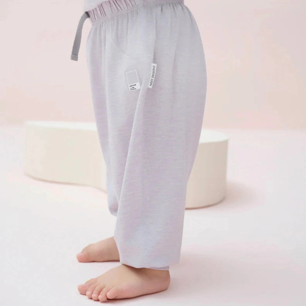 Nest Designs Bamboo Jersey Harem Pants Lavender Blue worn by toddler, showing elastic waistband and soft fabric.