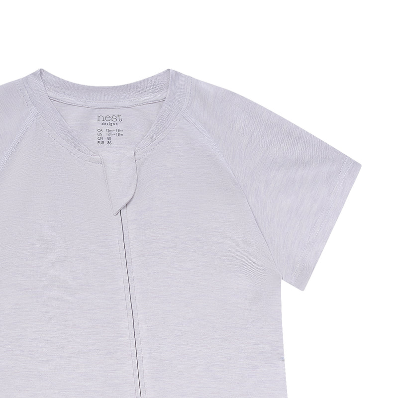 Nest Designs Bamboo Jersey Short Sleeve Slant Opening Romper Lavender Blue, laid flat with front slant opening tab.