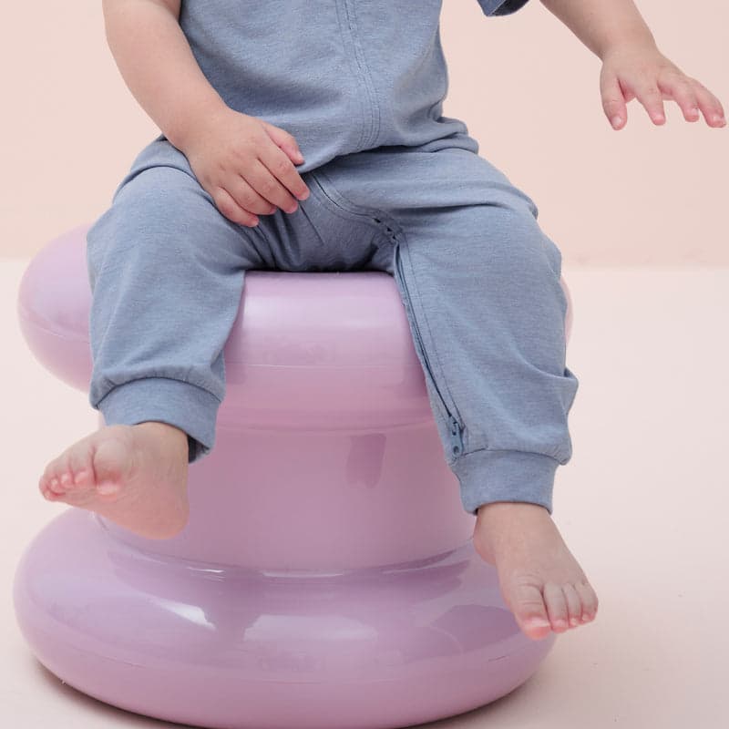 Nest Designs Bamboo Jersey Short Sleeve Slant Opening Romper Troposphere in blue; baby sits on a pink potty.