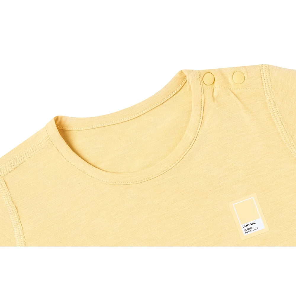 Nest Designs Bamboo Jersey Short Sleeve T-Shirt Sunset Gold laid flat with Pantone color swatch label