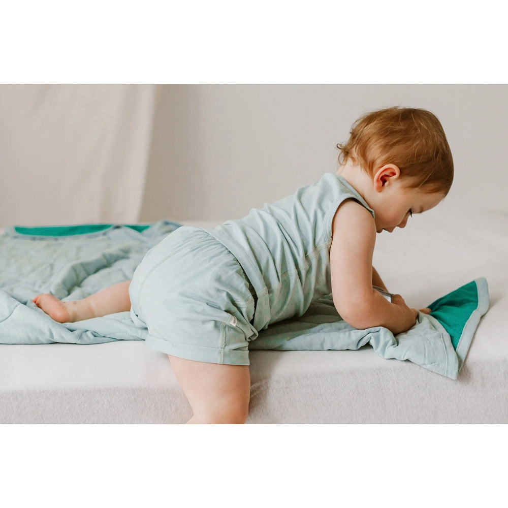 Nest Designs Bamboo Jersey Shorts Pantone Harbor Grey; baby crawls in soft, light grey-blue shorts.