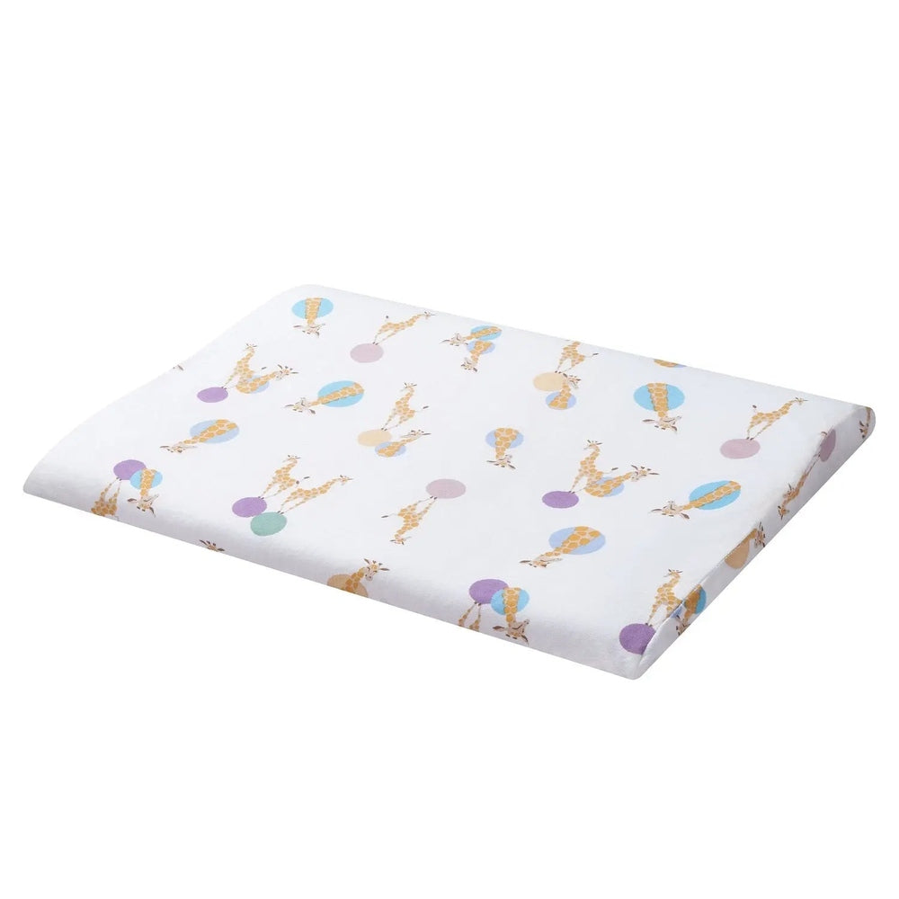 Nest Designs bamboo jersey toddler pillow and pillowcase laid flat on white fabric with pastel giraffe shapes.
