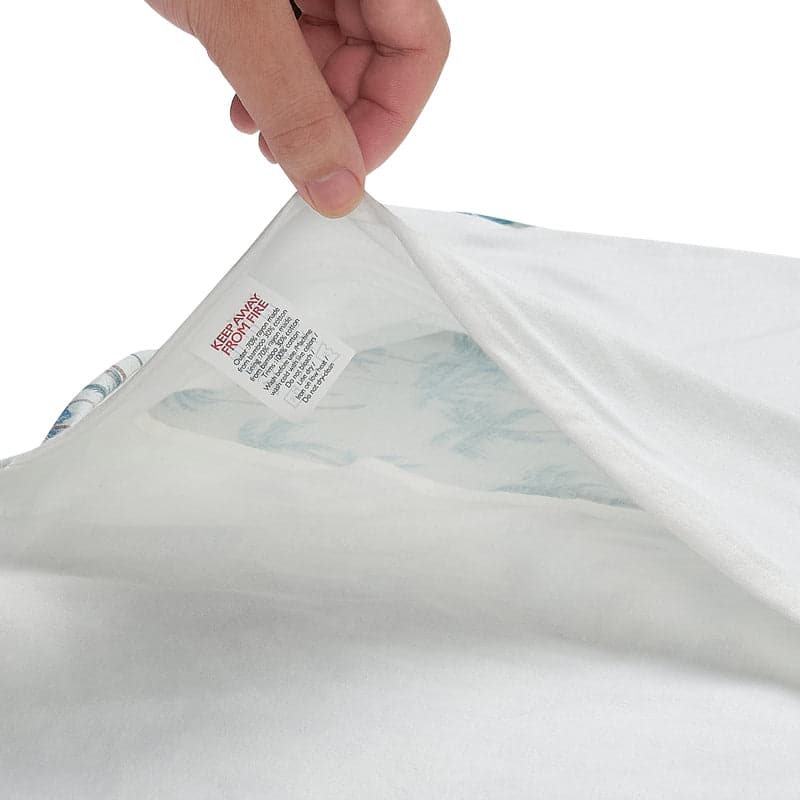 Nest Designs Bamboo Jersey Toddler Pillow with Pillowcase Pastel Waves, white and pale blue fabric being unwrapped.