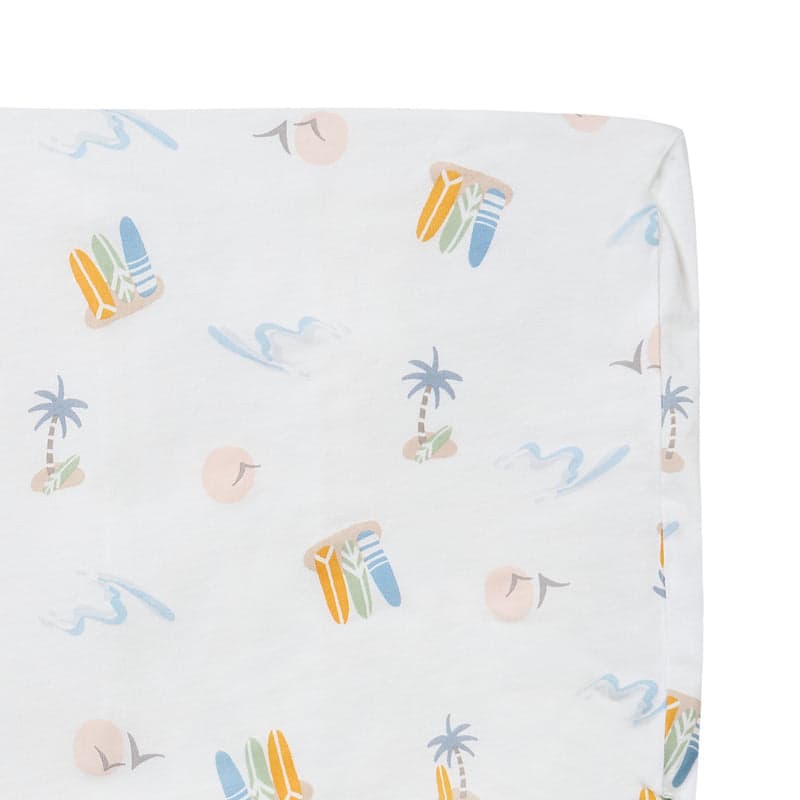 Nest Designs Bamboo Jersey Toddler Pillow with pillowcase in pastel waves, white fabric featuring pastel palm trees and surfboards.