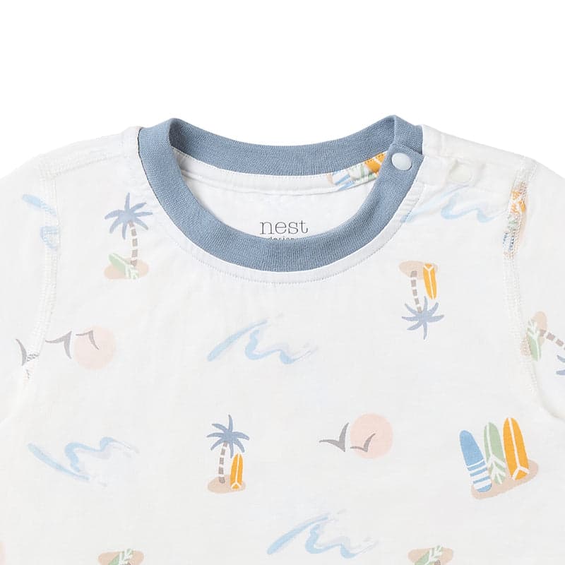 Nest Designs bamboo jersey two-piece short-sleeve PJ set in pastel waves, white pajamas with blue waves and palm print